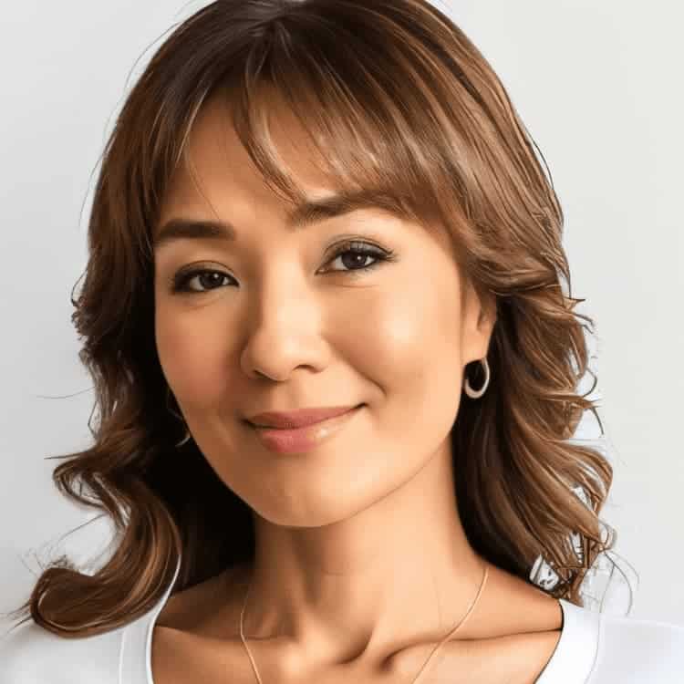 Female with brown hair framing the face, wearing a white shirt and gold necklace