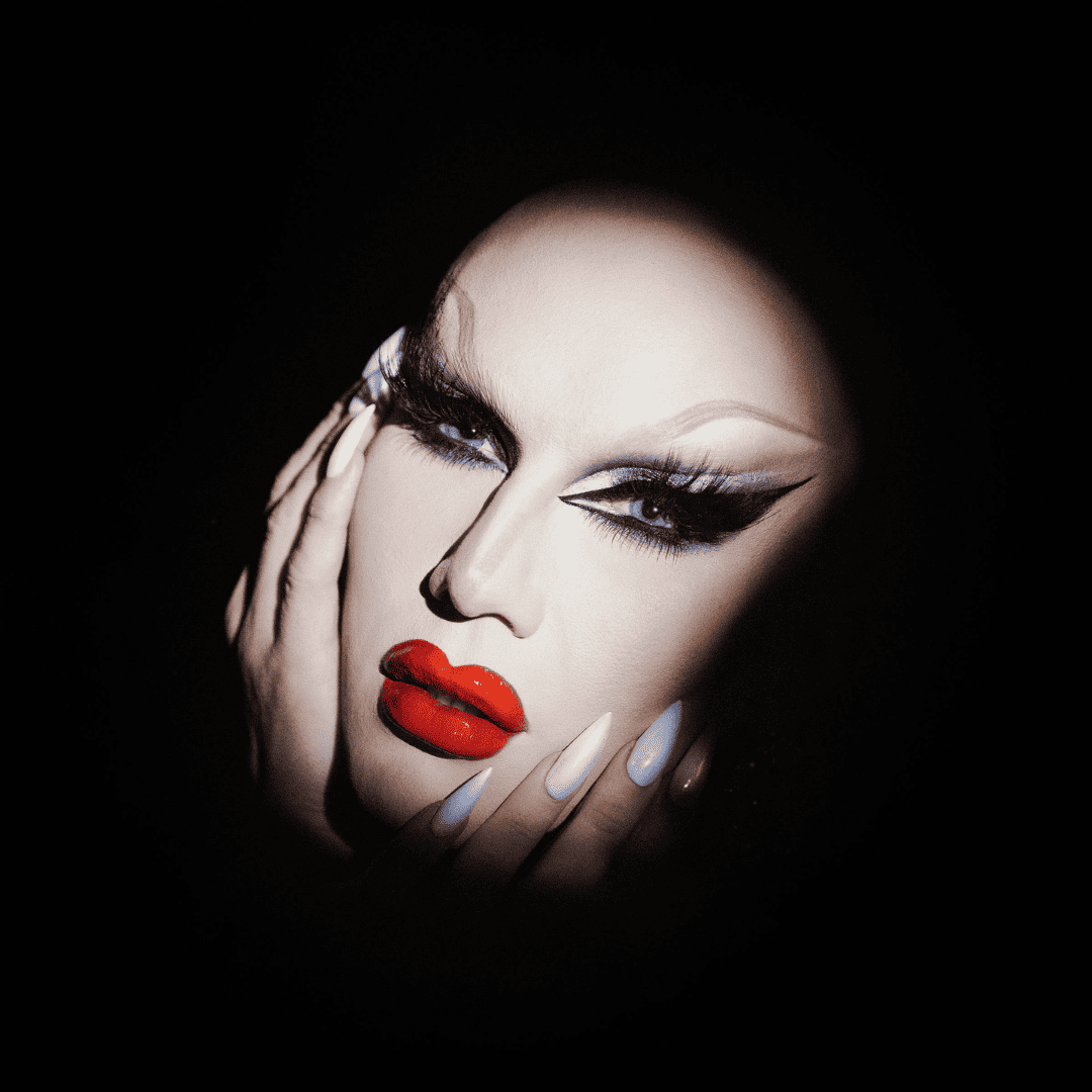 Gender fluid drag queen framing face with hands
