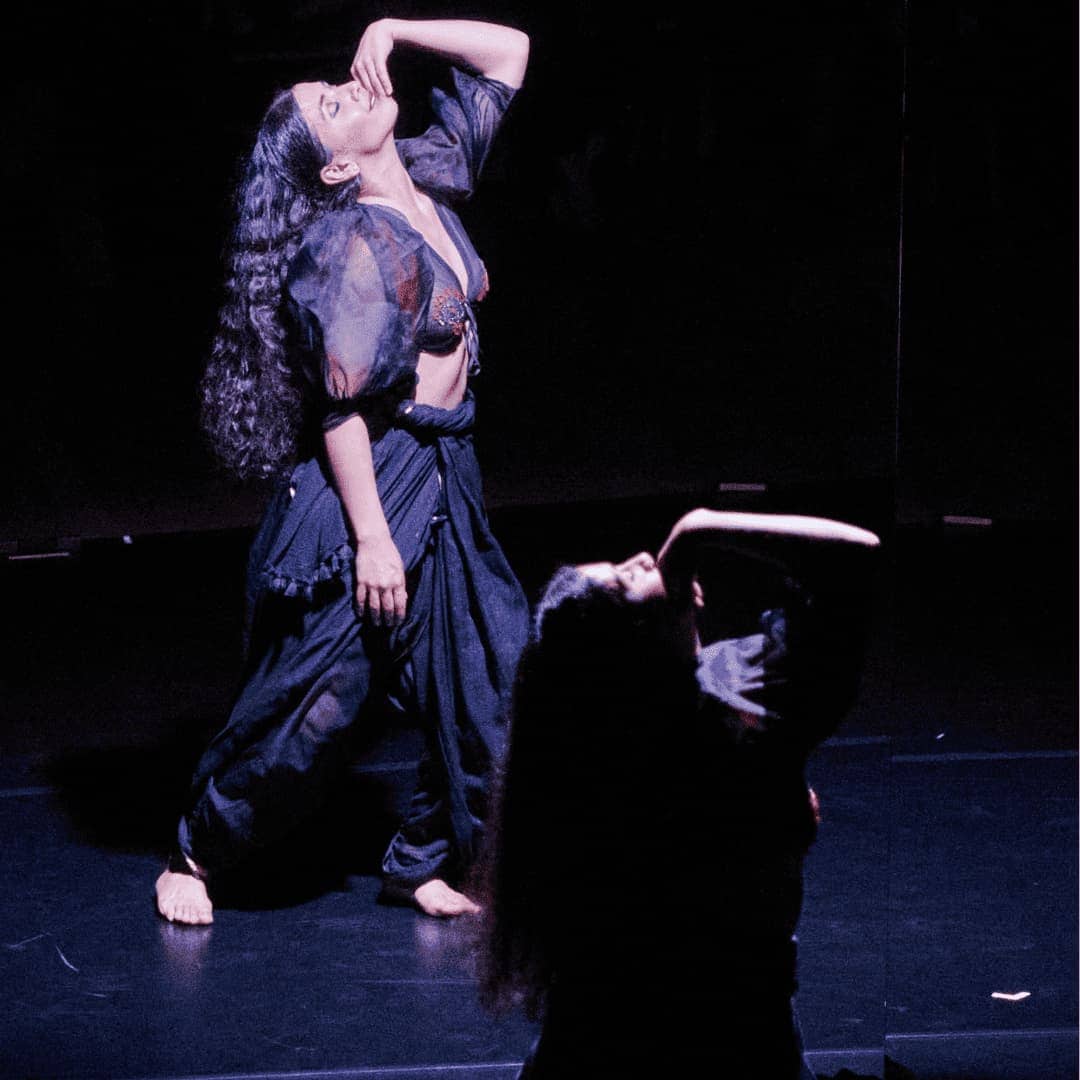 Image of dancer looking up towards the light facing mirror